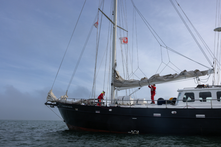 Sea Rangers on a ship at sea checking the sails and deck.