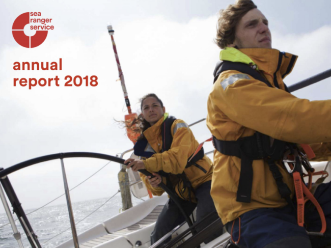 Front cover of the Sea Ranger Service annual report 2018. Image is of two Sea Rangers sailing on a calm blue ocean.
